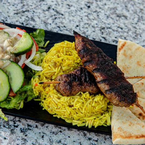 a plate of food with meat and rice