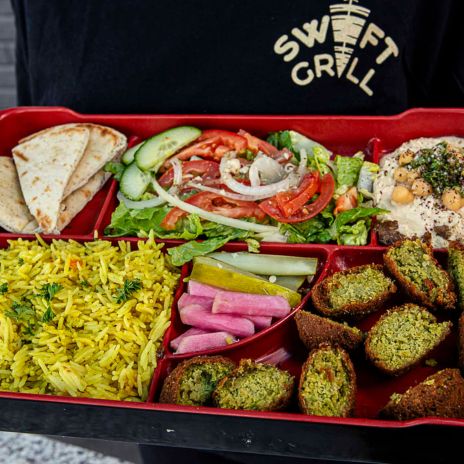 Falafel served with rice, PITA, garlic sauce, salad, hummus, pickles & Turnips served at Swift Grill