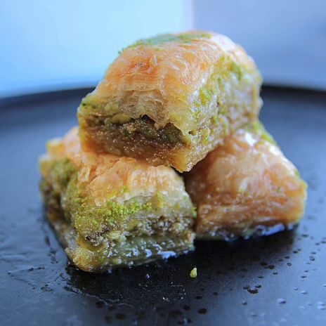 a pile of baklava on a black plate