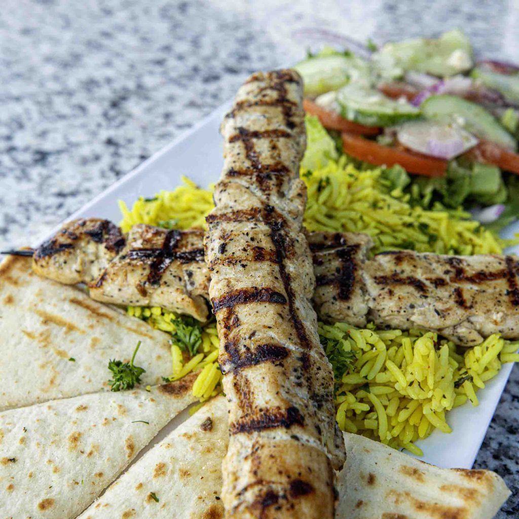 a plate of food with a side salad