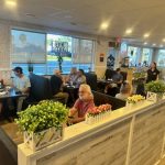 a group of people sitting at tables in Swift Grill restaurant